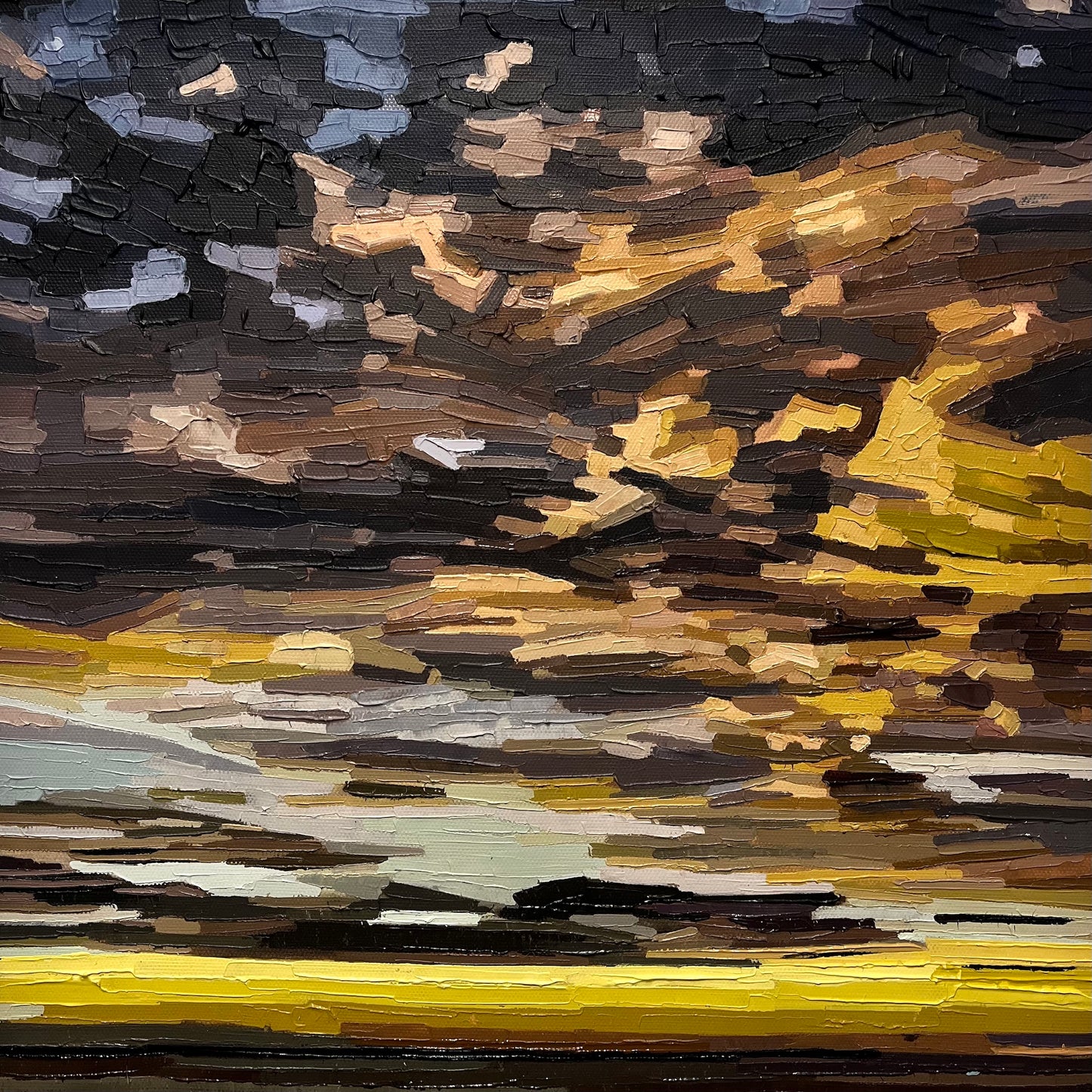 Abstract textural cloud painting with a mix of brown, black, and yellow colours. And some pale blue sky behind. 30x30cm in a wooden float frame.